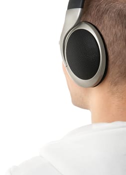 Young man listening to music. Back view.