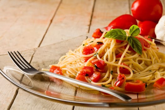 photo of delicious spaghetti with garlic and oil sauce on wooden table