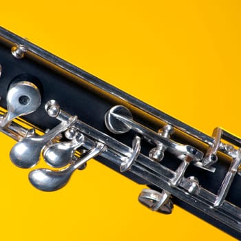 An oboe up close isolated against a yellow background in the square format with copy space.