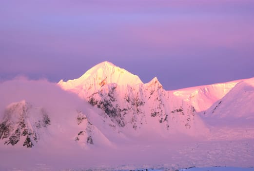Beautiful snow-capped mountains at sunset in Antarctica