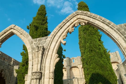 Bellapais Abbey stone arcs with trees in the middle. North Cyprus.