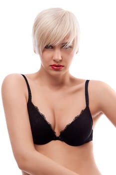 young and sexy blond woman wearing a black bra with hair style against white background posing while looking at the camera