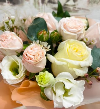 delicate bouquet of pink, white and yellow roses