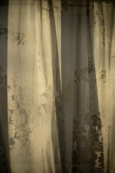 Curtains on window. Light through fabric. Morning sun in window of room.