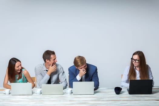 Business team working together at office on light gray background. all laughing. copyspace image