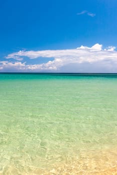 Beach on the tropical island. Clear blue water, blue sky. Beautiful vacation spot.
