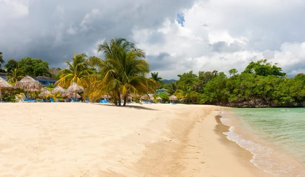 Beach on the tropical island. Clear blue water, blue sky. Beautiful vacation spot.