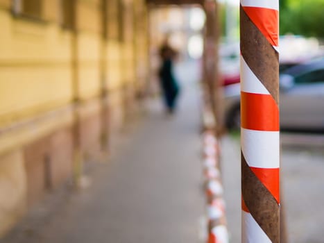 Blured backgroud with hazard tape,barricade tape, red white tape