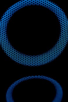 Blue circle in dark. LED glow. Abstract background on black. Mesh structure. Blue glow.