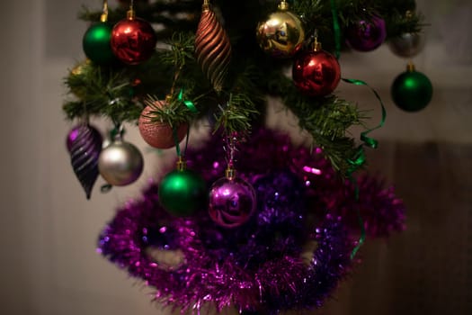 Christmas decoration on Christmas tree. Christmas tree at home. Christmas in apartment. Details of holiday.