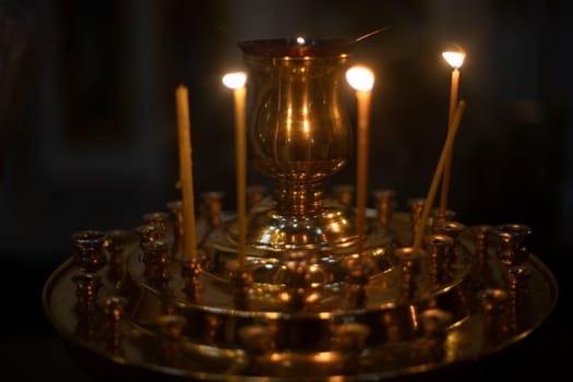 Candles in Temple. Wax candles are burning. Religious rite. Details of Faith. Christian Faith.
