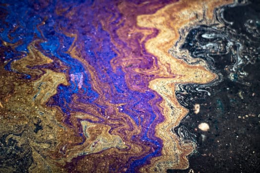 Spot gasoline. Puddle of fuel. Acid colors. Texture bright liquid.