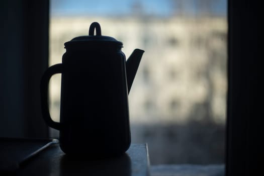 Kettle in kitchen. Water kettle. Darkens indoors. Kitchen details.