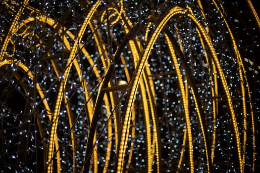 Design with lamps. Bright construction in city. Garlands on capital frame.