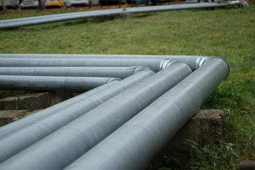 Steel pipe. Water pipeline in city. Metal profile. Urban communications.