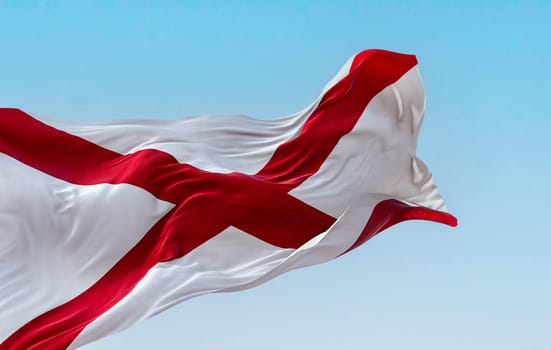 The state flag of Alabama waving in the wind on a clear day. Saint Andrew’s cross on a white background. 3D illustration render. Rippled textile