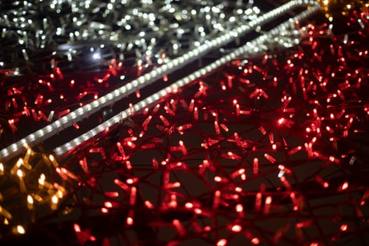 Red garlands. Texture made of LEDs. Bright lights. Decoration in city.