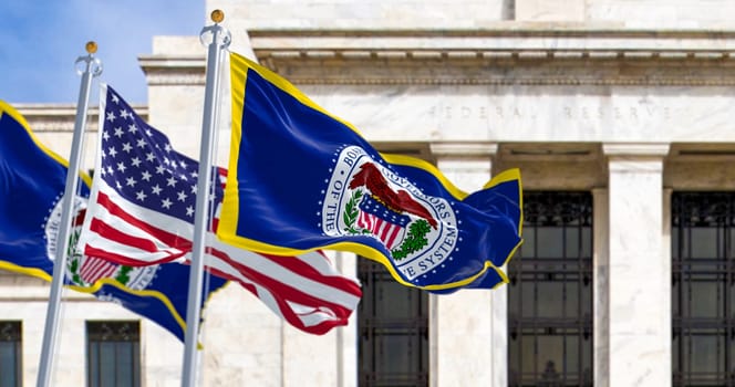 Washington, US, March 2023: flags of the Federal Reserve and the United States waving with the Eccles Building in the background. Illustrative editorial 3d illustration render.