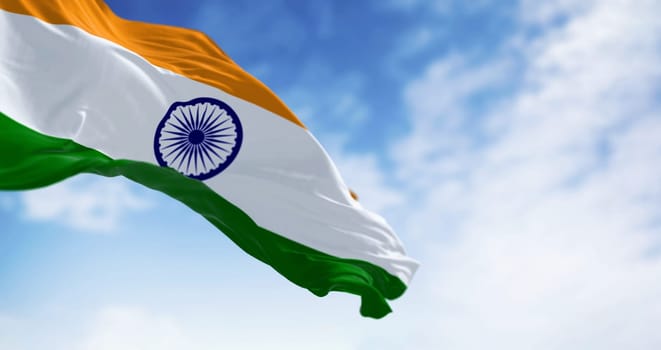 National flag of India waving on a clear day. Tricolor of saffron, white and green with a blue Ashoka Chakra in the center. 3d illustration render. Selective focus. Fluttering textile