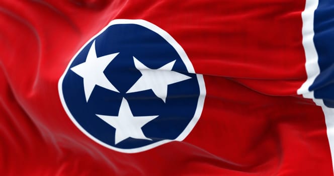 Close-up of the Tennessee state flag waving. Red field with a blue circle holding 3 white stars outlined in white. Blue strip on the fly. 3d illustration render. Textured background. Selective focus