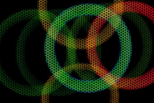 Texture green and red circles in grid on dark background. Glow in dark. Abstract disco background. Colored light. Circles intersect.