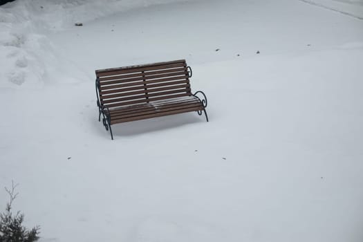 Empty bench in snow. Shop in park. Top view of empty space. Meeting place.