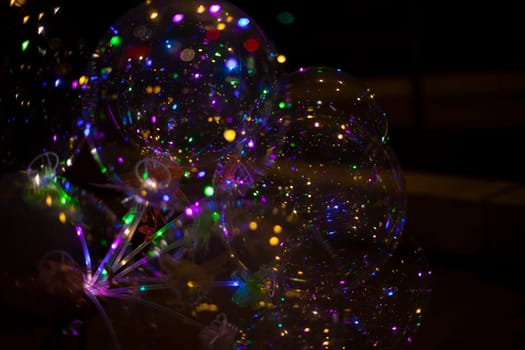 Colored balls in dark. LED Light. Transparent ball with colored lights. Beautiful glow.