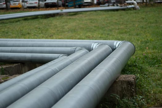 Steel pipe. Water pipeline in city. Metal profile. Urban communications.