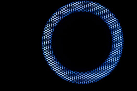 Blue circle in dark. LED glow. Abstract background on black. Mesh structure. Blue glow.