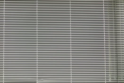Blinds in apartment. Window is closed from light. Texture of blinds. Window opening.