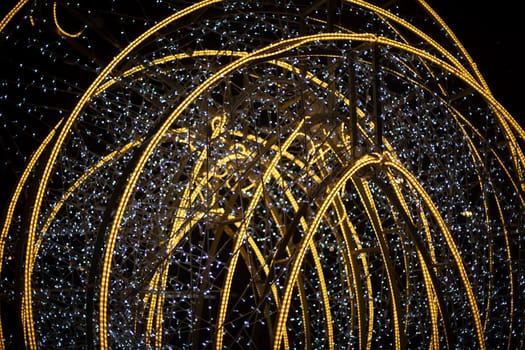 Design with lamps. Bright construction in city. Garlands on capital frame.
