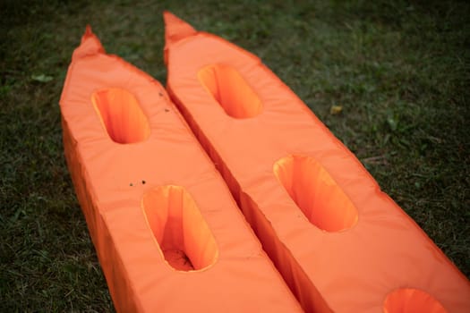 Sports equipment. Orange sports equipment. Item to play with. Things on site.