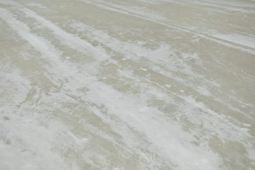 Ice in snow. Ice in hockey stadium. Texture of snow. Roller parts.