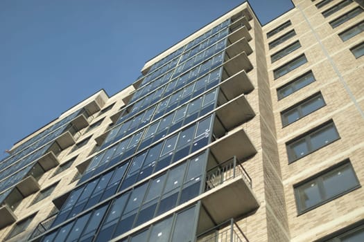 New building. Windows in new house. Balconies and windows. Details of building outside.