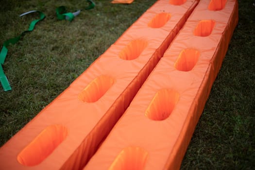 Sports equipment. Orange sports equipment. Item to play with. Things on site.