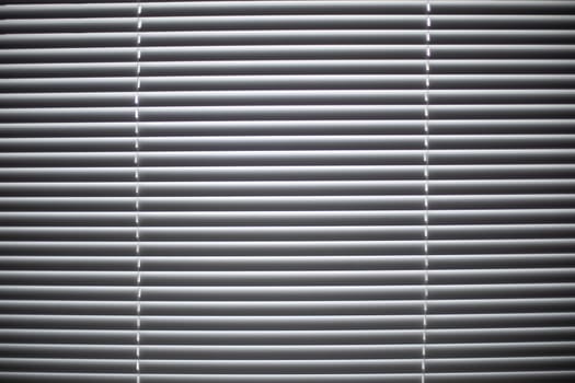 Texture blinds. Window in detail. Light from window. White blinds closed.