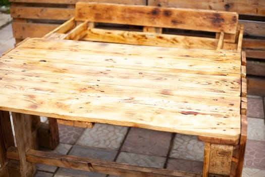Craft table. Table of boards. Wooden furniture. Outdoor bar. Interior details.