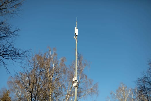 Pole with radio transmitter. Internet antenna. Telecommunications in city. Steel pole.