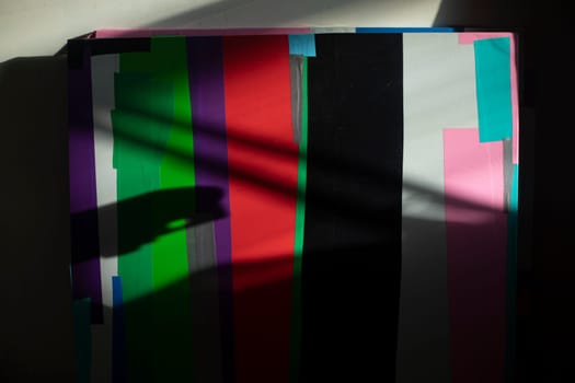 Abstract picture of colored flaps. Chaotic drawing on canvas. Drawing with film. No symmetry in arrangement of crooked scraps.