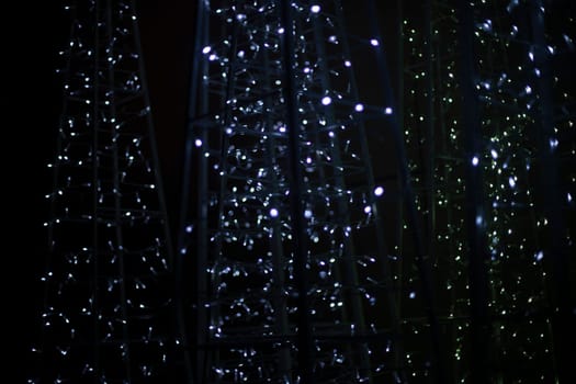 Texture from garlands. Led bulbs. White lights in dark. Glow on black background.
