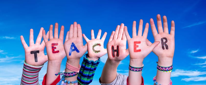 Children Hands Building Colorful English Word Teacher. Blue Sky As Background.