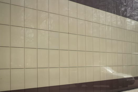 Wall of building. Modern of house. Beige tiles. House cladding.