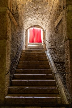 Old corridor with red curtain at the end. Concept for mystery, gothic, escape, hope
