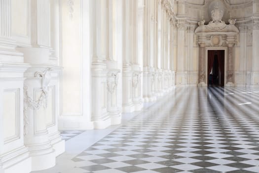 Reggia di Venaria Reale, Italy - October 2022: corridor perspective, luxury marble, gallery and windows - Royal palace