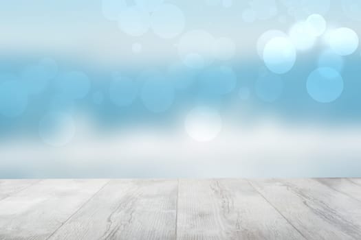 Empty wooden table over abstract blurred natural cloudy blue sky background. Space for your food and product display montage.