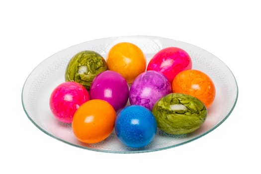 Colorful easter eggs arranged on a glass plate isolated on a white background.