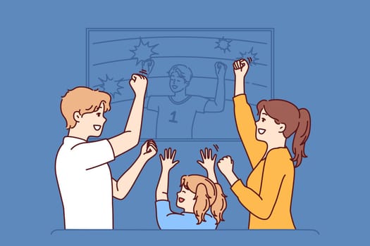 Family watches football ball on TV and celebrates victory after seeing goal scored by players of favorite sports team. Family of mom and dad with daughter watching football derby enjoying match