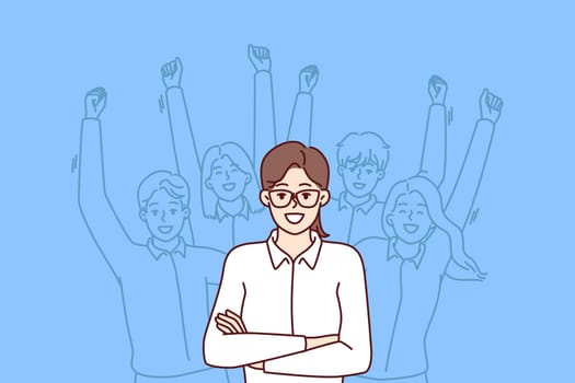 Woman leader standing with arms crossed near team located behind and making victorious wave of hands. Businesswoman leader or company manager posing for advertising banner of consulting corporation