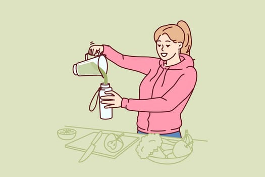 Woman using blender to make vegetable smoothie during detox diet or after morning run. Young vegan or vegetarian girl consumes cocktail of vegetables containing vitamins and nutrients for detox