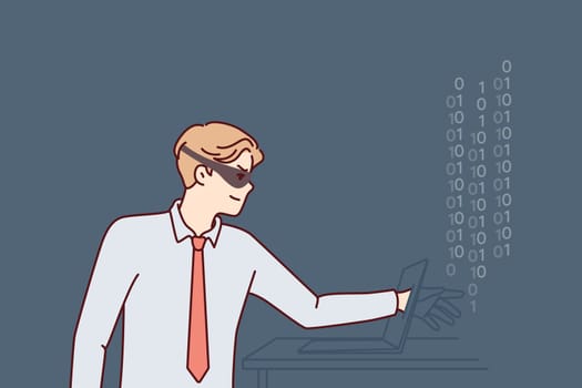 Man hacker in mask hiding face reaches out to laptop screen to steal important information or commit cybercrime. Guy hacker makes digital fraud and hacks computer via internet or local network